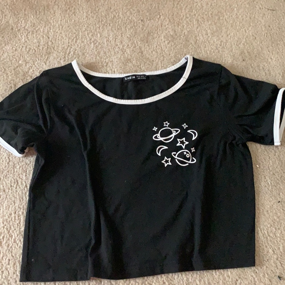 cropped tee with a small planet design.